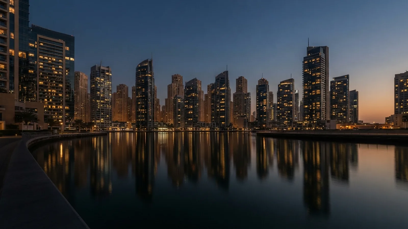 Residential towers at dusk seen across water in Dubai